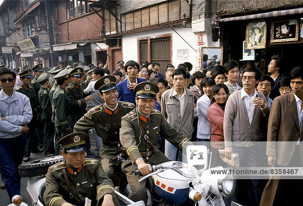 Army officers control crowd for VIP visit in Shanghai  China in 1980s