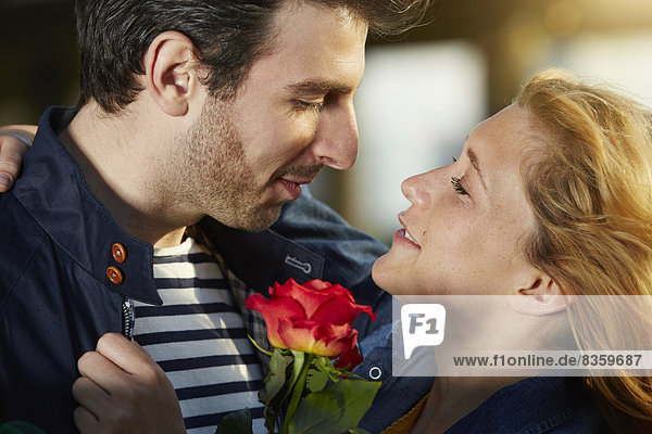 Germany  Dusseldorf  Young couple with red rose