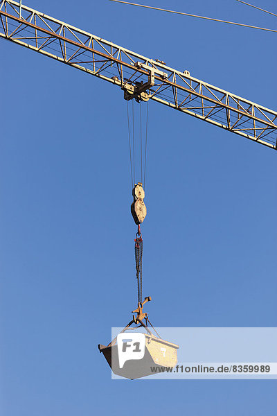 Germany  Bavaria  construction crane with container against blue sky