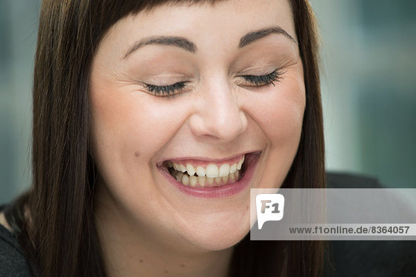 Young woman laughing  eyes closed