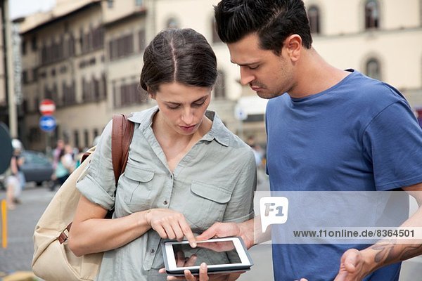 Young couple using digital tablet  Florence  Tuscany  Italy