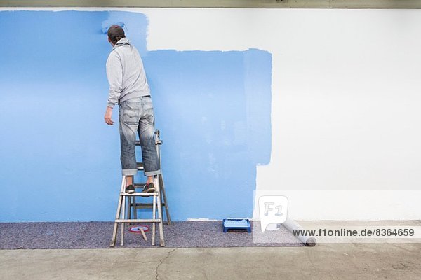 Rückansicht des Mannes Malerei Wand blau