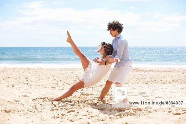 Couple tangoing on beach