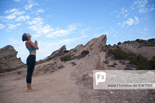 Side view of woman doing yoga at Vazquez Rocks  LA