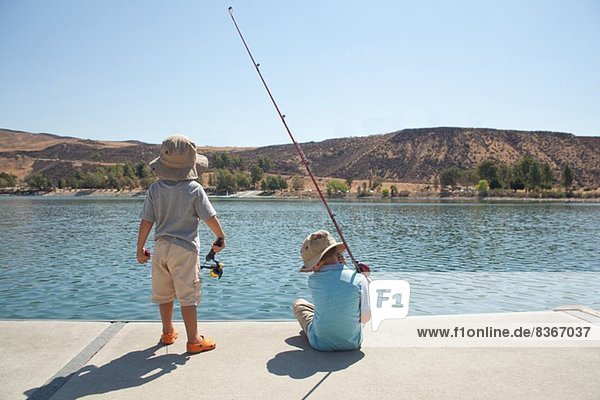 Boys fishing by lake