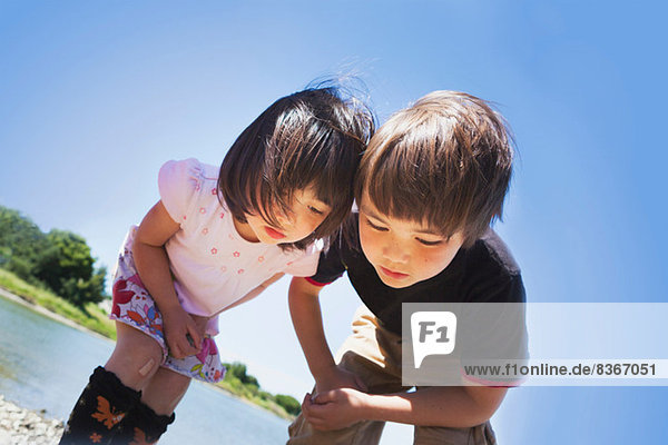 Boy and girl looking down at something