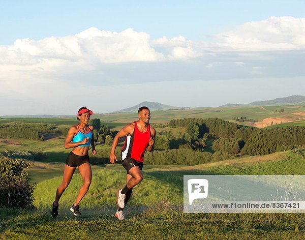 Young couple jogging in landscape  Othello  Washington  USA