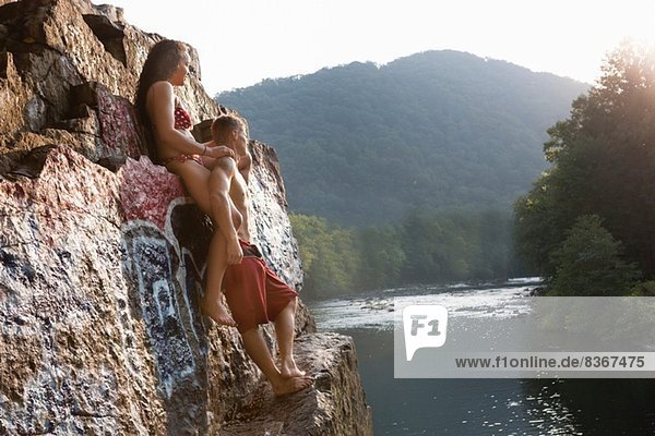 Young couple standing on rock ledge  Hamburg  Pennsylvania  USA