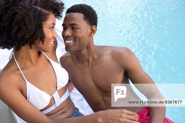 Portrait of young couple at poolside
