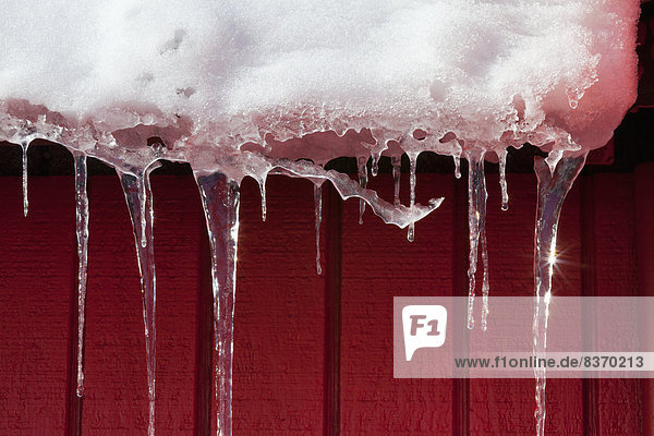 Wand rot Sonnenlicht schmelzen Eiszapfen Schnee