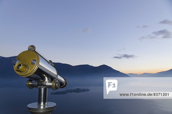 Binoculars With A View Of A Mountainous Landscape And Fog Over Lake Maggiore Isole Di Brissago  Ticino  Switzerland
