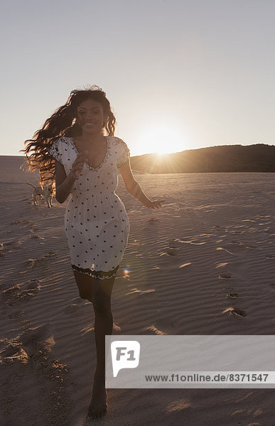 A Young Woman With Long Hair Running On The Beach At Sunset Tarifa  Cadiz  Andalusia  Spain