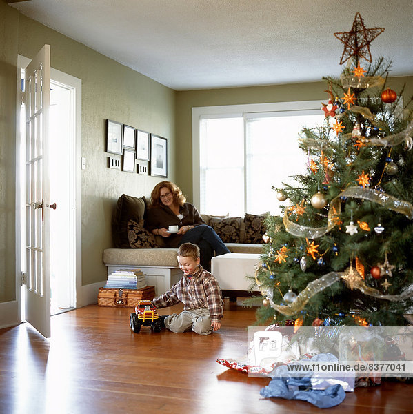 Mother And Son In Living Room At Christmas Time