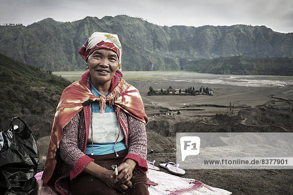 Portrait Of A Woman Sitting On The Side Of A Trail To Gunung Bromo (Bromo Volcano) Java  Indonesia