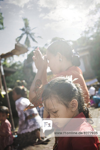 Women Praying During Kuningan Festival Bali  Indonesia