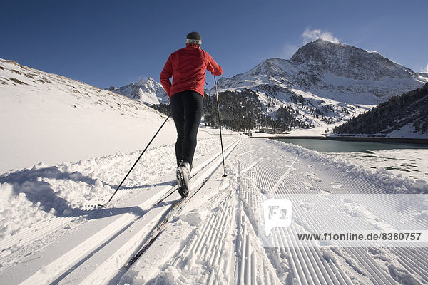 Cross-country skier  right the Laengental Reservoir  Kuehtai  Sellrain Valley  Tyrol  Austria