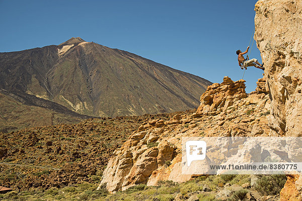 Climber at the Piedras Amarillas  Mt Pico del Teide  3718m  at back  Teide National Park  Tenerife  Canary Islands  Spain