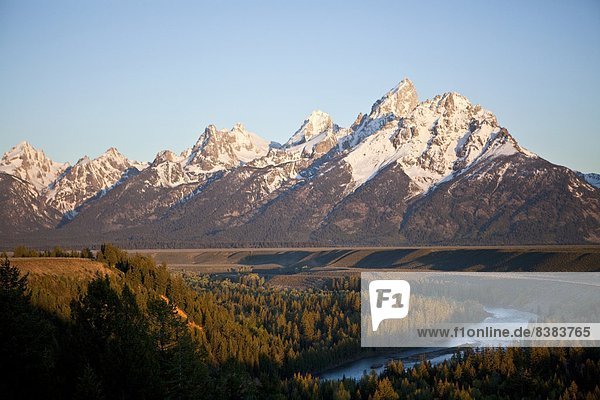 The Tetons loom over the Snake River and the valley of Jackson Hole  Wyoming.