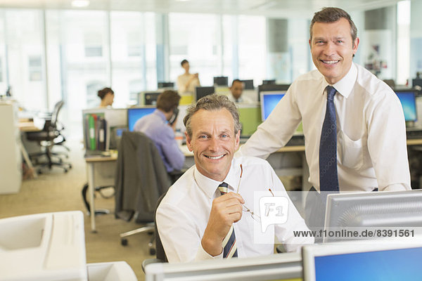 Businessmen smiling in office