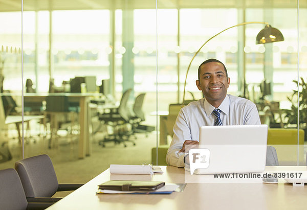 Businessman smiling at desk
