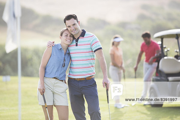 Couple hugging on golf course