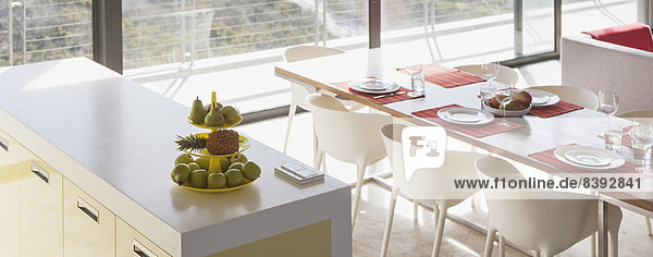 Frühstücksbar und gedeckter Tisch im modernen Wohnraum