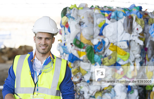 Worker smiling in recycling center