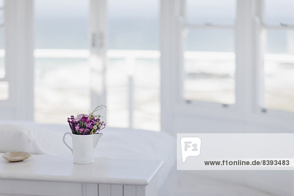 Blumenvase auf dem Schreibtisch im Schlafzimmer mit Blick auf den Ozean