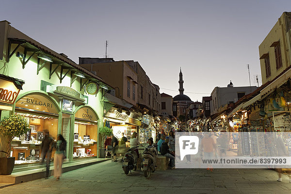 Socrates Road or Odos Sokrates with jewellery stores and souvenir shops  at twilight  historic town centre  Rhodes  Island of Rhodes  Dodecanese  Greece
