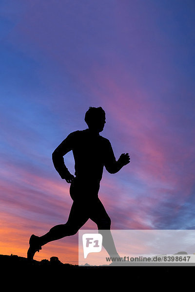 Silhouette eines Joggers im Sonnenuntergang