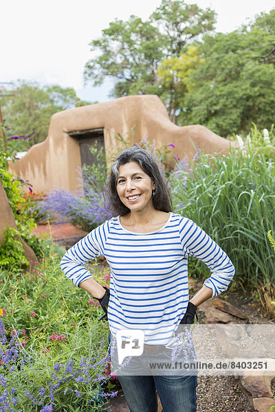 Hispanic woman working in garden