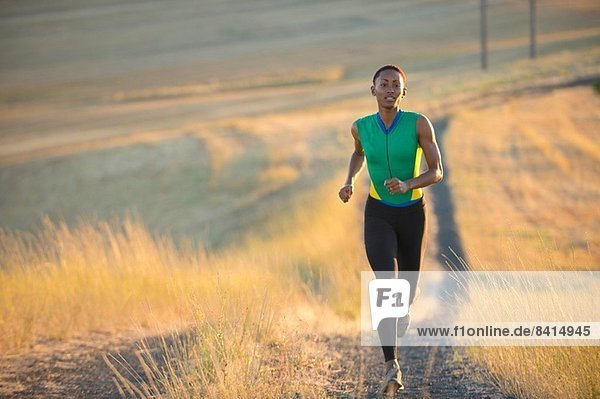 Young woman running on dirt track  Bainbridge Island  Washington State  USA