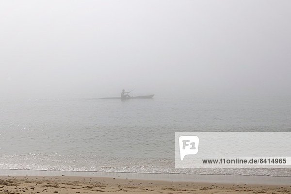 Sea kayaker on misty sea  Poole  Dorset  UK