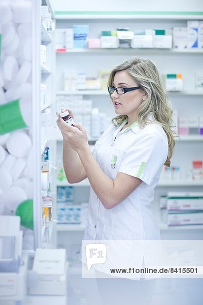Pharmacist looking at box of medication
