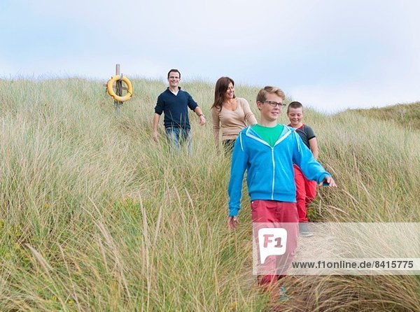 Family strolling coastal path