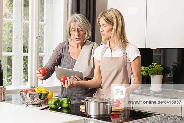 Mother and daughter preparing food