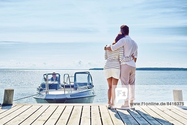 Young couple on pier looking at view  Gavle  Sweden