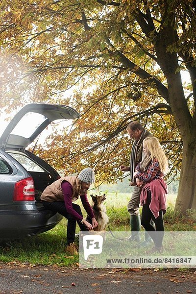 Family and dog preparing for walk from car boot  Norfolk  UK