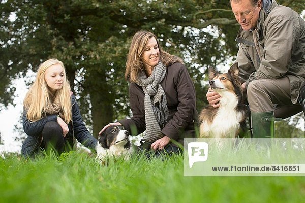 Senior couple and granddaughter out with dogs
