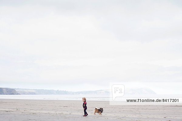 Boy with dog on beach