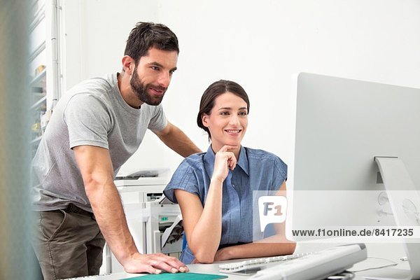 Two colleagues using computer