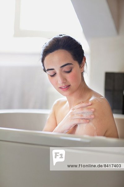 Portrait of serene young woman enjoying bath