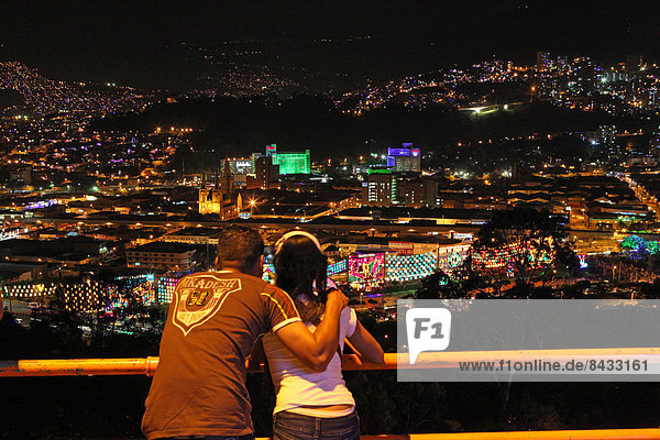 Colombia  South America  Medellin  night  night shot  couple  look  hills  city  lights  town  city  city  embrace  happy  young  Christmas lighting  Alumbrado  Navideno