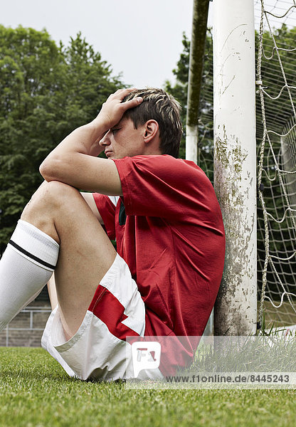 Frustrated soccer player on field