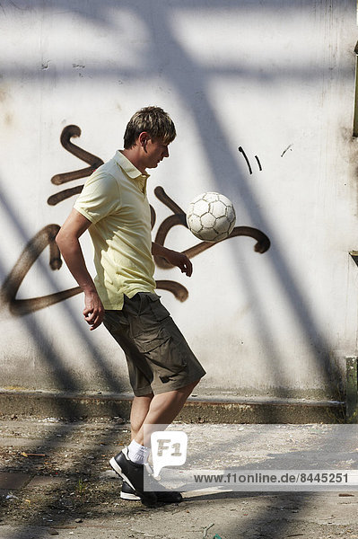 Mann spielt Straßenfußball