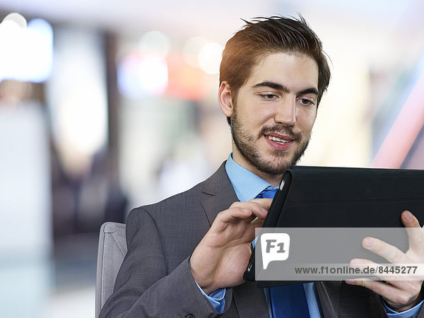 Portrait of businessman using tablet computer