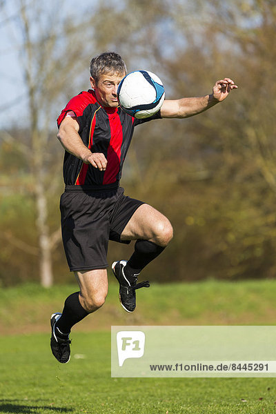 Soccer player with ball on field