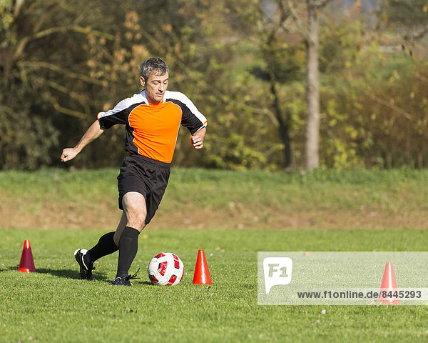 Soccer player passing a slalom course