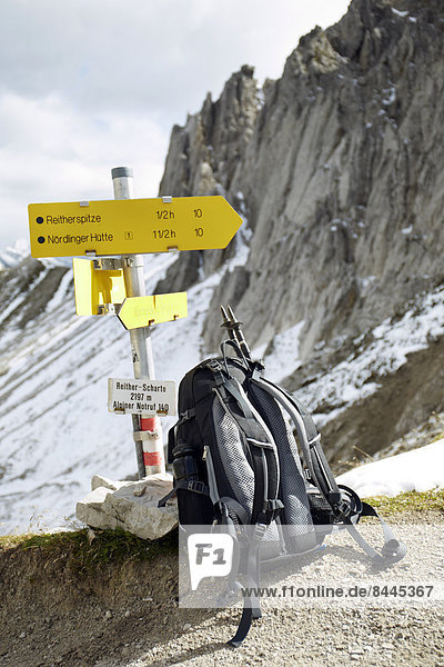 Austria  Tyrol  Karwendel mountains  Rucksack under sign post