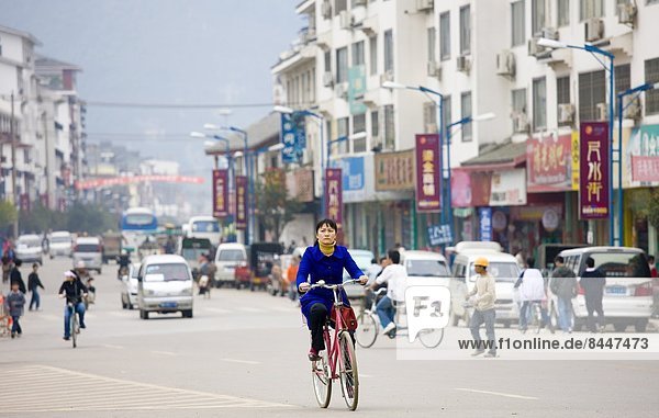 Woman on a bicycle in Yangshuo street China